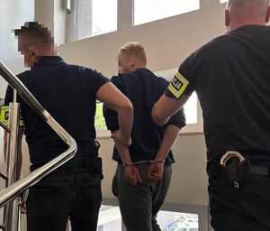 zatrzymany prowadzony przez policjantów